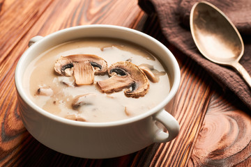 Bowl of mushroom soup on a wooden table