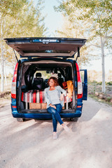 woman and border collie dog in a van. Travel concept