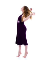 Little girl in a dress developing in the wind.