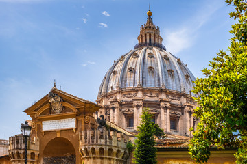 Fototapety  Rome, Vatican, Italy - Panoramic view of St. Peter’s Basilica main dome by Michelangelo Buonarotti with the Fountain of the Sacrament seen from the Vatican Gardens