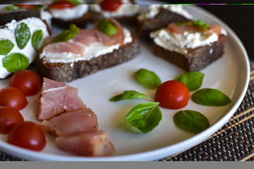 Fototapeta na wymiar Sandwiches with ham, basil and tomatoes
