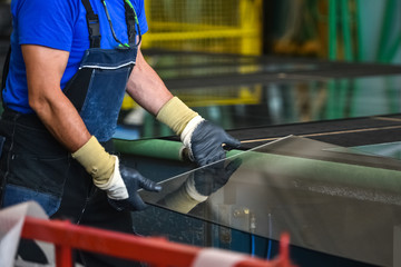 worker is cutting glass panes