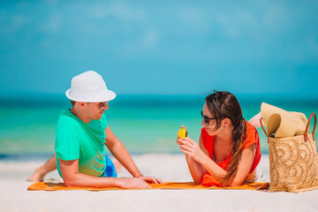 Happy couple taking a self photo on a beach on holidays