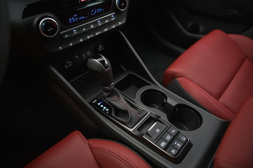 Interior of a car. Cup holders and automatic gearbx shifter.