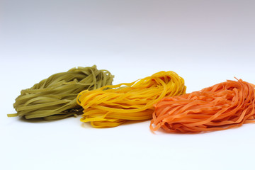 Isolated colored spaghetti nests on a white background.