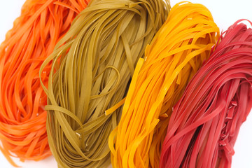 Isolated colored spaghetti nests on a white background.