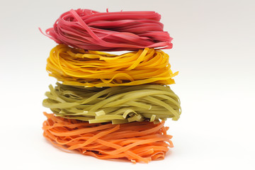 Isolated colored spaghetti nests on a white background.
