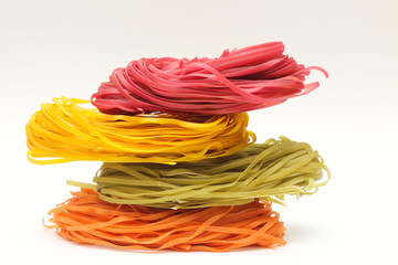 Isolated colored spaghetti nests on a white background.