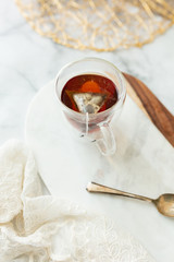 Obraz na płótnie Canvas Black tea steeping in clear mug on marble