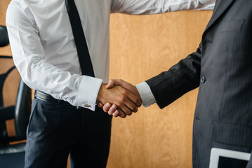 Handshake of partners, completion of the transaction in the office. Business