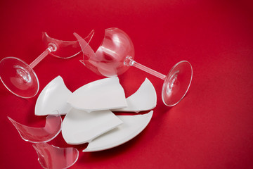 Broken Plate or broken water glass on the on the red background The concept of accidents in the...