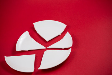 Broken Plate or broken water glass on the on the red background The concept of accidents in the...