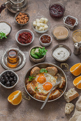 Fried eggs with tomato and different appetizers, turkish breakfast