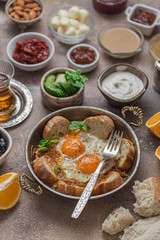 Fried eggs with tomato and different appetizers, turkish breakfast