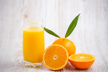 Natural fresh fruit oranges in a wooden background backdrop, half cut oranges, orange juice, vitamin C, for good health everyday