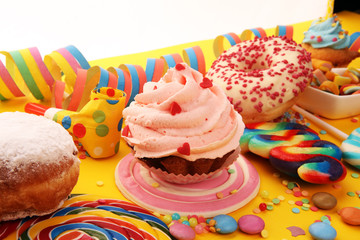 candies with jelly and sugar and streamers. colorful array of different childs sweets and treats.
