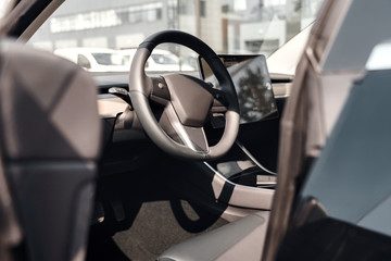 Transportation. Car interior steering wheel and autopilot system close-up