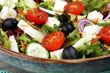 Authentic fresh salad in a stone cup with dumbbells excercise equipment, measuring tape on table. healthy lifestyles, good health Concept with fresh ingredients