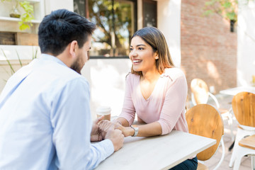 Hispanic Lovers Enjoying Date At Cafe
