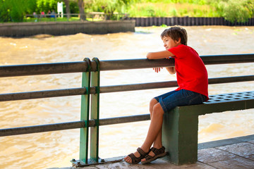 dreaming boy looking at the river