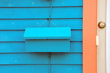 A bright bright turquoise and coral Newfoundland jellybean house is symbolic of local St. John's architecture and is a unique style of dwellings located in maritime Canada.