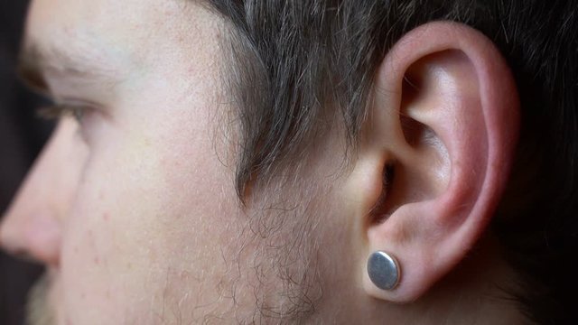 A man scratches his ear and thinks
