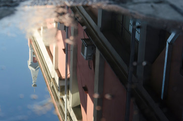 Recoleta cultural center reflected in a puddle of water