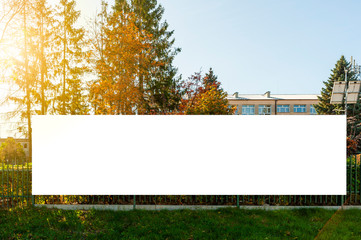 Blank white advertising banner on the fence