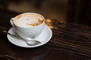 Cup of coffee latte on old wooden background