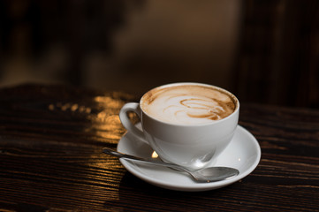Cup of coffee latte on old wooden background