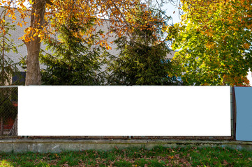 Blank white banner for advertisement on the fence. © diesirae