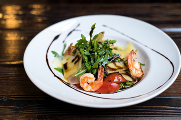 Grilled shrimps and fresh green salad served for lunch