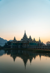 Chan Thar Gyi temple reflection in water at sunset in Hpa-An, Myanmar.