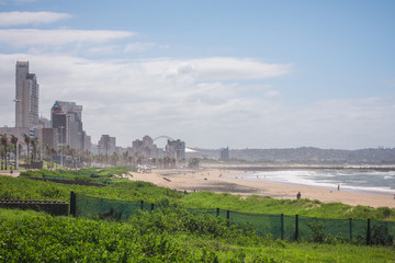 Fototapeta na wymiar Panorama photo of Durban beachfront or cityscape. View from the gardens towards the big city skyscrapers on a sunny day.