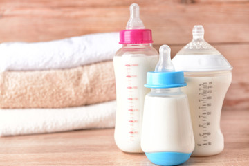 Obraz na płótnie Canvas Bottles of milk for baby on wooden table