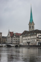Vertical photo of Fraumunster church and a part of Zurich old town in a cold, cloudy winter like environment.