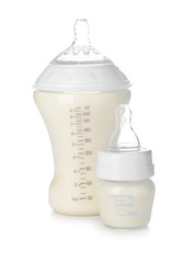 Bottles of milk for baby on white background