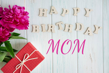 Happy birthday mom. Greeting card design for mom's birthday with a teddy bear and a heart. Flat...