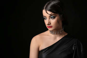 Beautiful fashionable woman on dark background