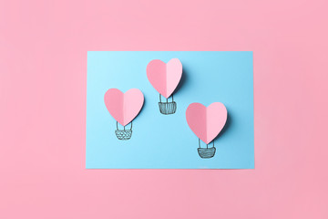 Fototapeta na wymiar Creative composition with paper hearts on pink background