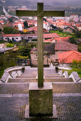 Stone cross symbolizing the christian religion at the top of a stairwell.