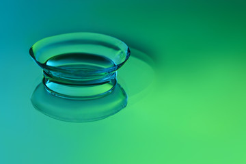 Contact lens on color background