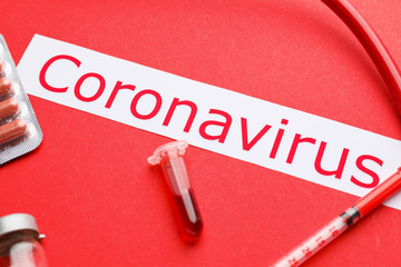 Test tube with blood sample and text Coronavirus on color background