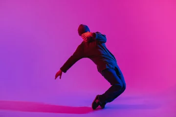 Wandcirkels Dansschool Young Man in a Jumper Dancing Contemporary Dance in Studio. Breakdancing. Dance School Poster. Copy Space. Battle competition announcement. Pink and Blue Background.  © Сергей Уланов