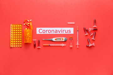 Test tubes with blood sample and medicines for Coronavirus on color background