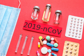 Protective mask and medicines for Coronavirus on color background