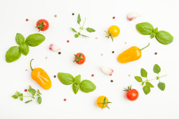 Fresh cherry tomatoes, oregano, basil, parsley, pepper, garlic, peppercorns on white background. Top pattern. Top view.