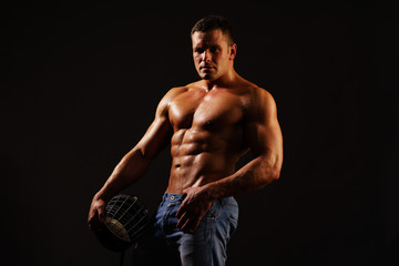 Naklejka na ściany i meble Muscular sporty man with helmet. Sexy sportsmen in black background. Ab and biceps. Strong mans, bodybuilder. Copy space. Beautiful male torso. Sexy man, naked body, nude male. Sexy body.
