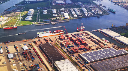 Fototapeta premium aerial shot of port docks and containers for transportation and port ships logistics with tilt-shift focus technique - all trademark elements or logos were cloned out of image