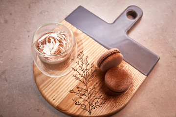 Exclusive painted art cutting board made of wood organic serving dishes with taste food cuisine coffee break milk cream macarons cappuccino drink sweet desert.